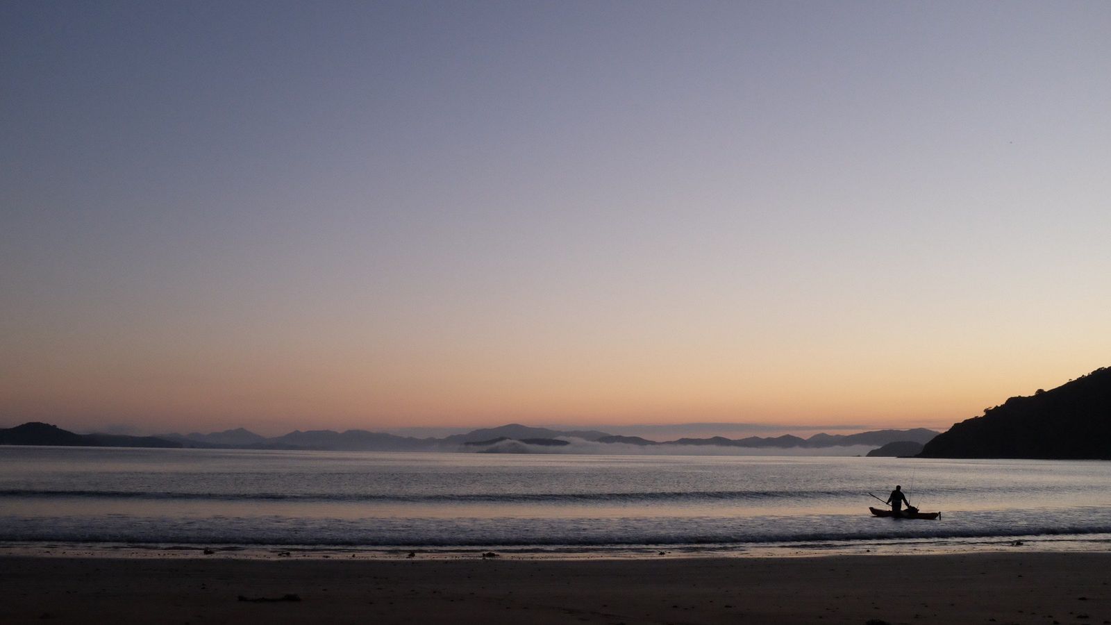 A lone kayak angler at dawn in the Bay of Islands near Russell