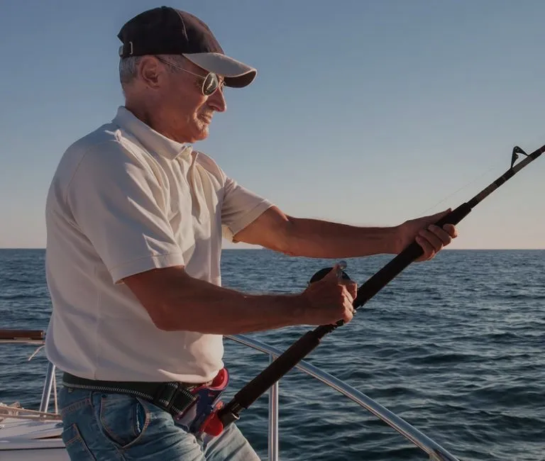 An angler fishing from a Red Boats launch